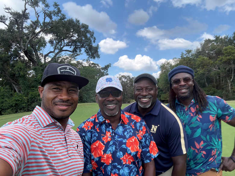 Four Gang Green Golf Club members together on the course under a bright sky